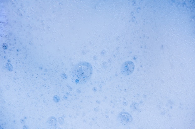 抽象的な背景の白い石鹸の泡のテクスチャ。泡のあるシャンプーフォーム