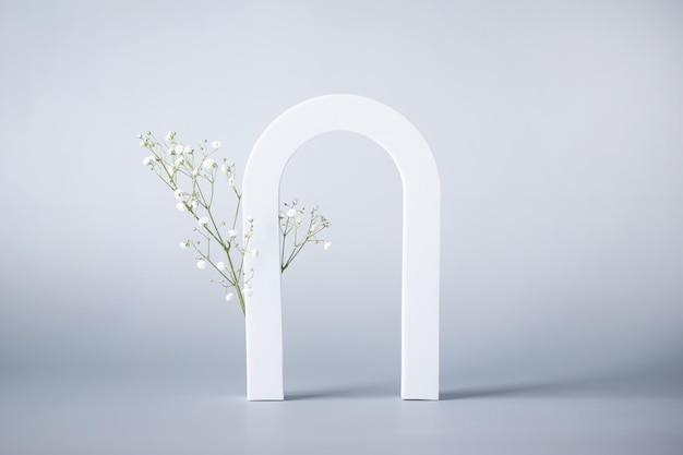 Photo abstract background with arch and flowers for product presentation modern scene for cosmetic products presentation