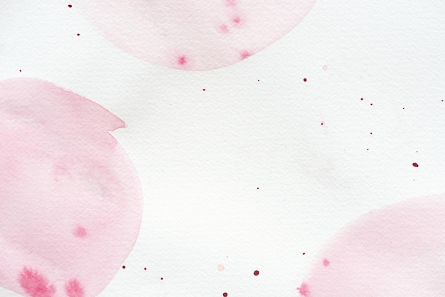 Abstract background with light pink watercolor painting and splatters