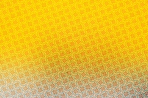 Abstract background with a pattern of geometric shapes in yellow and orange colors