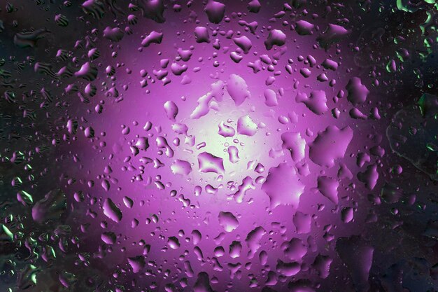 Abstract background with water drops on purple background