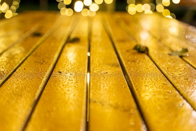 Abstract background of a wooden table with fallen leaves