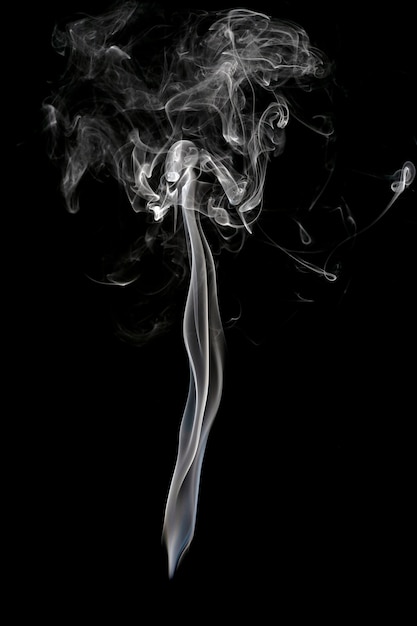 Abstract beautiful art. White smoke from the incense isolated on a black background. 