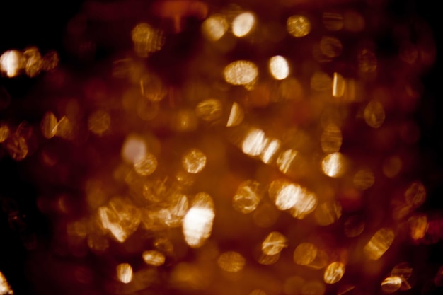 abstract black background, gold bubble lights or snowflakes falling at night