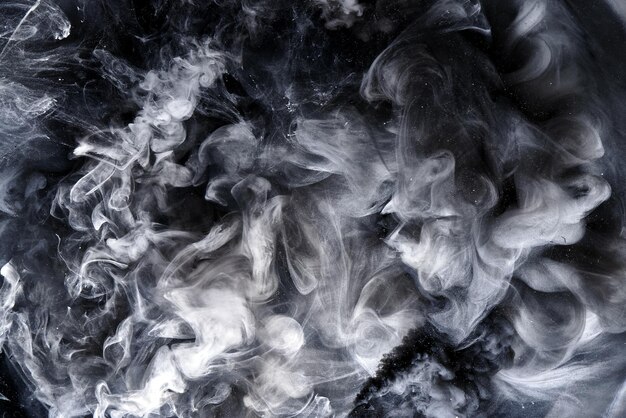 Abstract black and white swirling smoke background. Cumulus thunderclouds, mysterious and frightening sky. Paints colors of depression and negative emotions