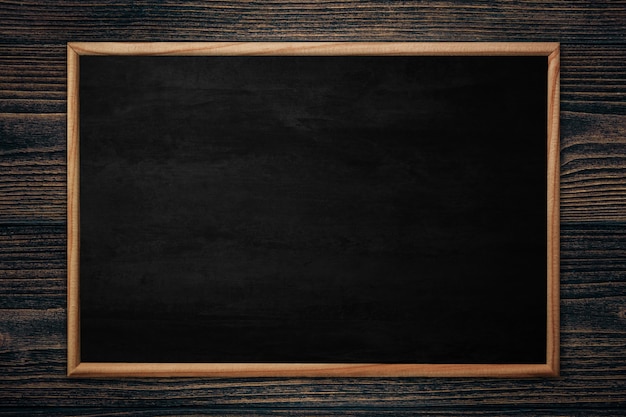 Abstract blackboard or chalkboard with frame on wood