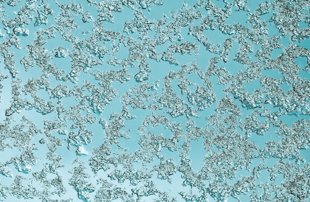 Abstract blue background of snow stuck to glass