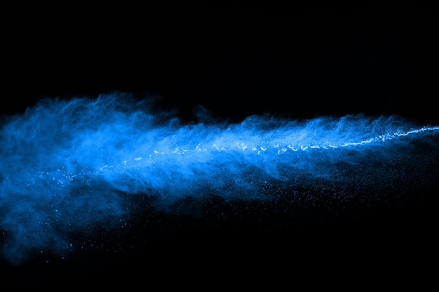 Abstract blue powder splatted on black background