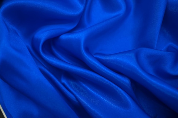 Abstract blue Satin Silky Cloth Fabric Textile Drape with Crease Wavy Folds background