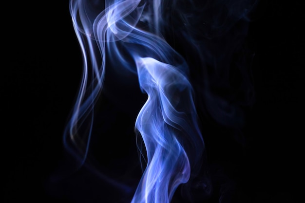 Abstract blue smoke on a black background photo