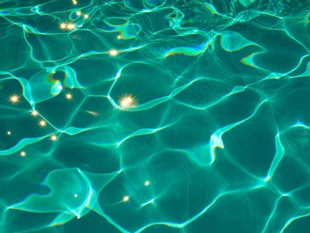 Abstract blue turquoise texture of swimming pool water with reflections