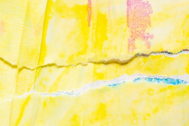 破れた紙の背景のテクスチャに抽象的な青黄色の水彩絵の具
