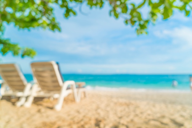 Abstract blur beautiful luxury umbrella and chair on sea and beach