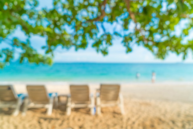 abstract blur beautiful luxury umbrella and chair on sea and beach