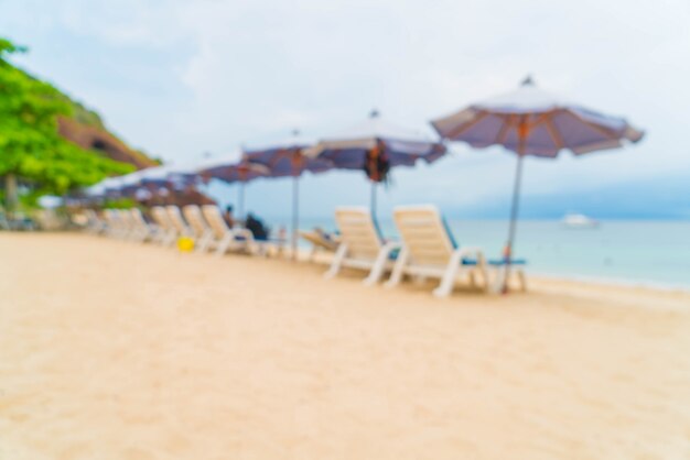 Abstract blur beautiful luxury umbrella and chair on sea and beach