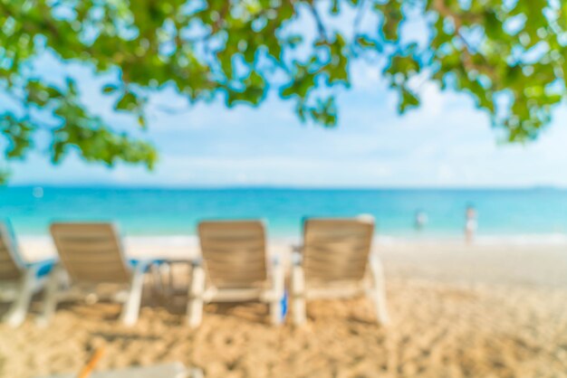 abstract blur beautiful luxury umbrella and chair on sea and beach