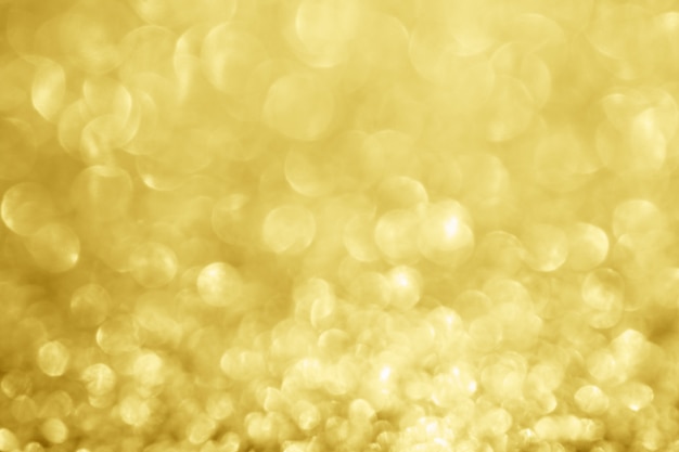 Photo abstract blur gold glitter sparkle defocused bokeh light background
