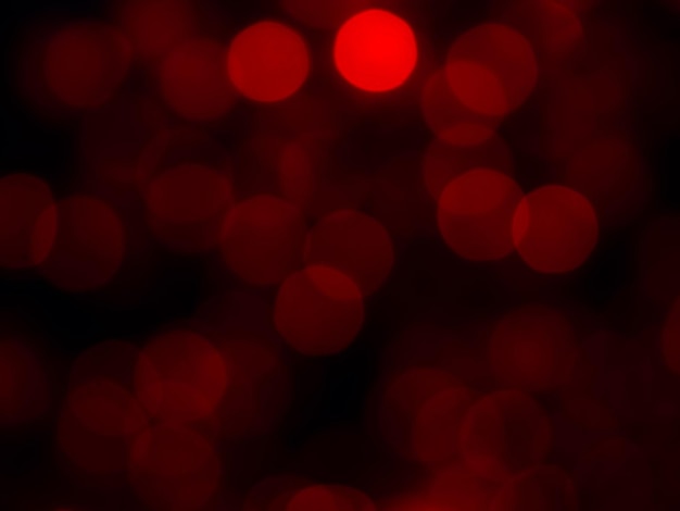 Abstract blur image of red light of beautiful bokeh on black background Blurred festive night party and celebration bokeh background