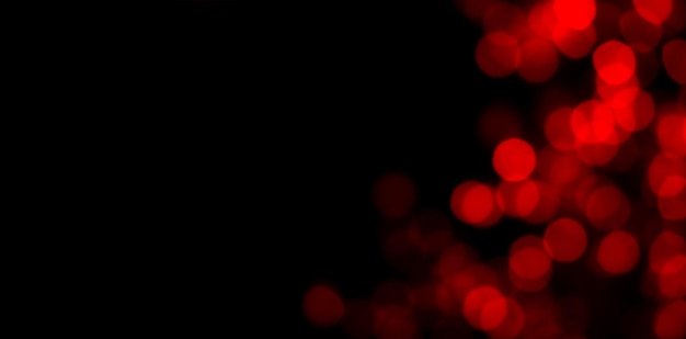 Abstract blur image of red light of beautiful bokeh on black banner background with copy space Blurred festive night party and celebration bokeh background