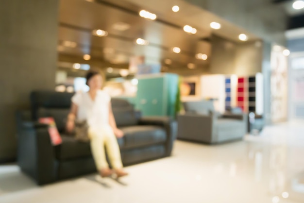 Abstract blur sofa in furniture store shop interior with bokeh light background