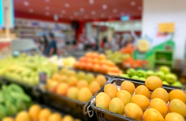 Abstract blur in supermarket with oranges and variety of fruits