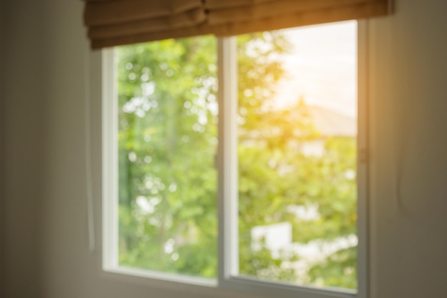 Abstract blur window interior with green garden view background