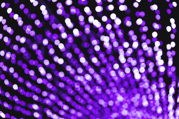 Abstract blurred background, purple defocused lights Bokeh on black background, glittering circle pattern