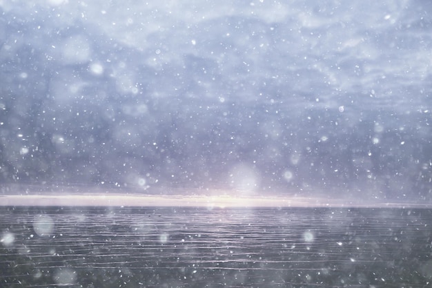 abstract blurred background, snow falls on the sea, northern cold sea, climate winter view