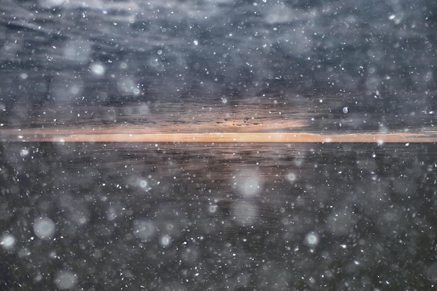 abstract blurred background, snow falls on the sea, northern cold sea, climate winter view