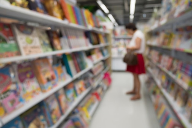 抽象的なぼやけた本屋の棚の通路の背景