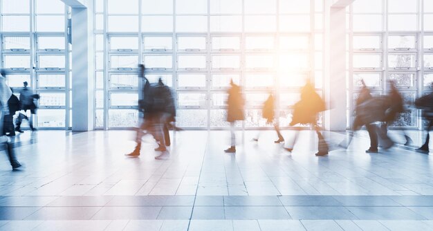 abstract blurred business people rushing in a floor at a business center. ideal for websites and magazines layouts