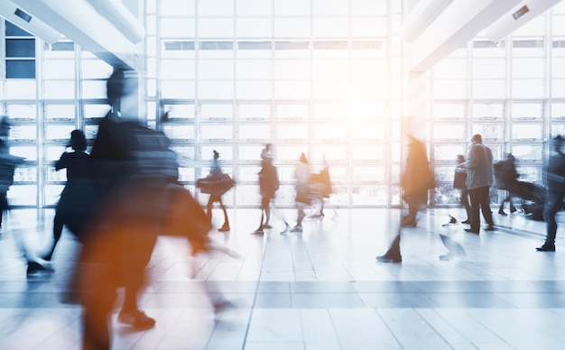 Abstract blurred businnes people walking in a modern office
center. ideal for websites and magazines layouts