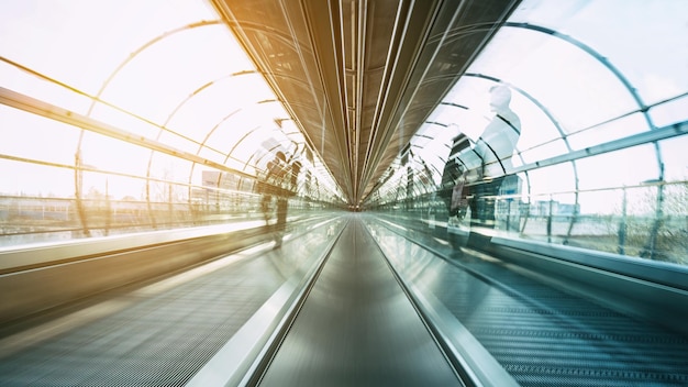 Abstract Blurred commuters rushing on a escalator in a modern airport. ideal for websites and magazines layouts