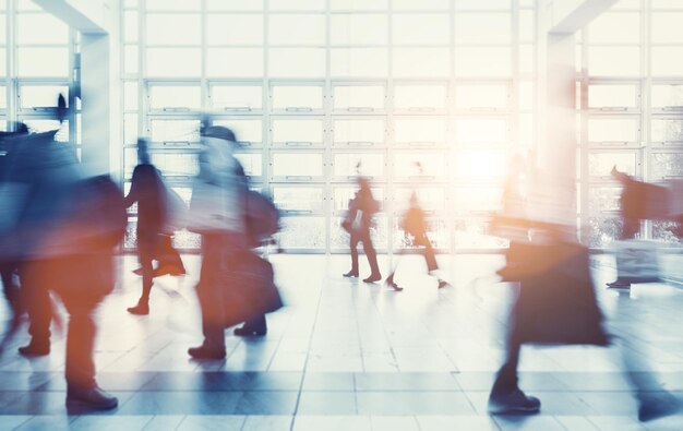 abstract blurred people walking in a modern floor at a trade show. ideal for websites and magazines layouts