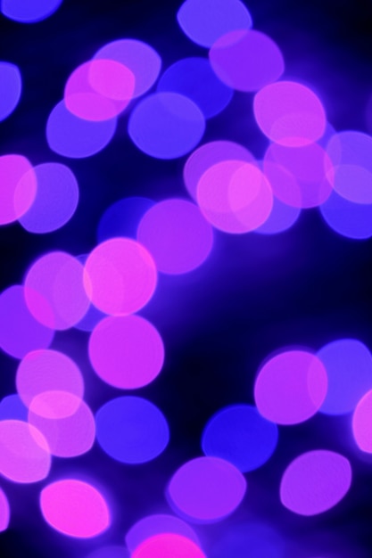 Abstract Blurred Purple and Pink Illuminated Decorating Light on Dark Background