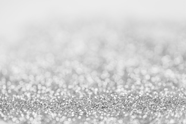 Astratto sfocato scintillante sfondo bokeh d'argento. concetto di design di decorazioni festive