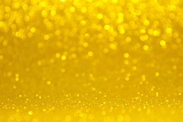 Abstract bokeh golden and yellow colors defocused circular background. Christmas light or season greeting background.