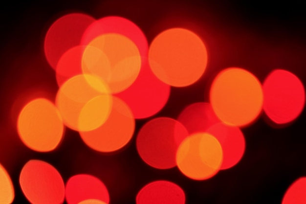 Abstract Bokeh of Orange and Red Illuminated Decorating Light on Dark Background