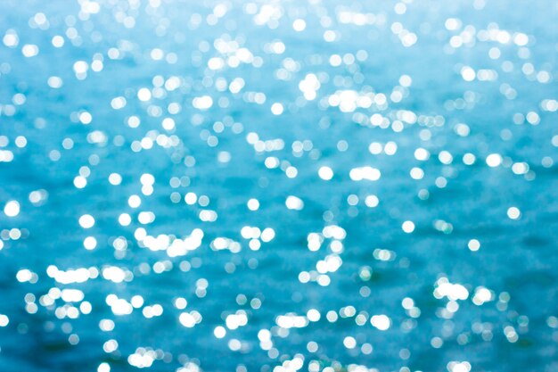 Abstract bokeh sunlight background with summer blue sea.