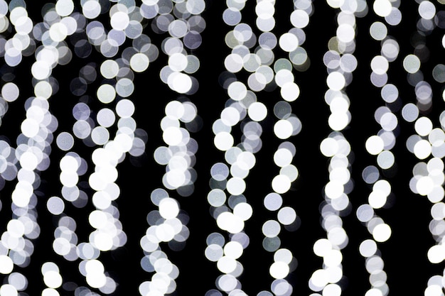 Abstract bokeh of white city lights on black background