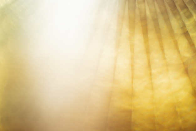 Abstract bright yellow or gold blur bokeh background