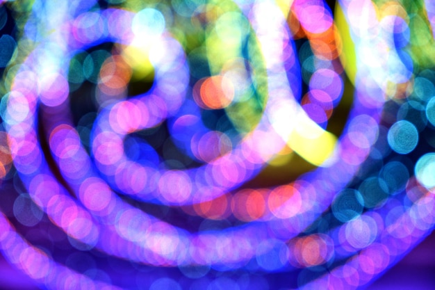 Photo abstract christmas background, bokeh of colorful garlands.