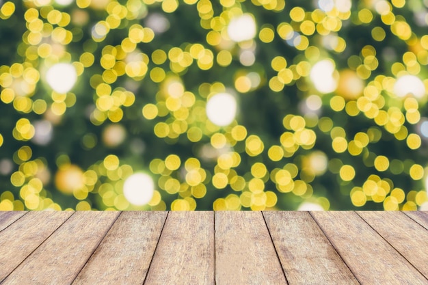 Abstract Christmas holiday bokeh light background with empty wood table for create montage product