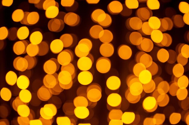 Abstract circular bokeh background of christmaslight bokeh from garlands background for screensaver defocused lights blurred bokeh with yellow color lights