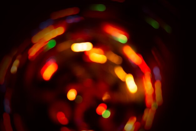 Abstract circular bokeh background with copy space. Abstract bright bokeh on black background. Glitter defocused lights background.