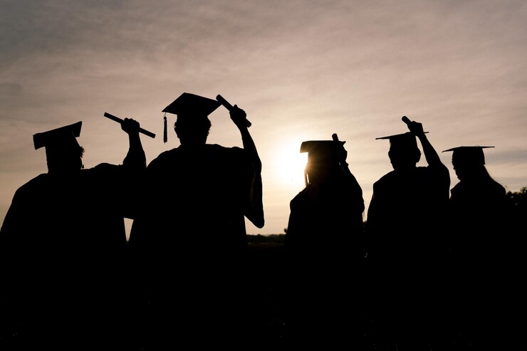 Abstract Close up Rear view group of the university graduates at Silhouette sunset
