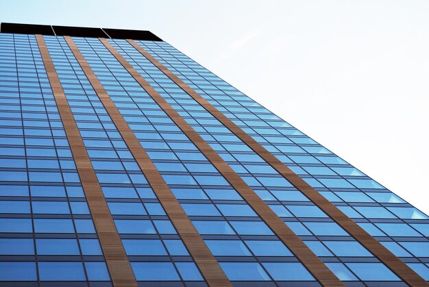 Abstract closeup of the glassclad facade of a modern building covered in reflective plate glass