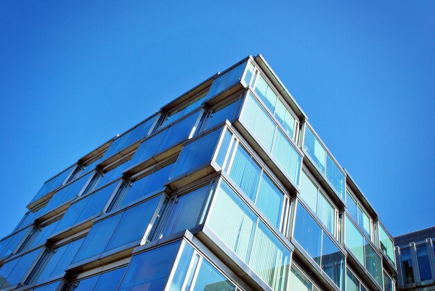 Abstract closeup of the glassclad facade of a modern building covered in reflective plate glass