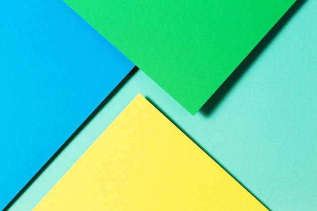 Carte a colori astratte geometria piana composizione laica sfondo con tonalità di colore blu giallo e verde