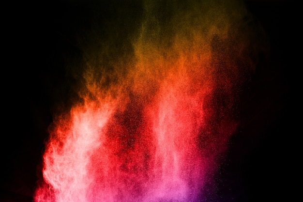 Abstract colored dust explosion on a black background.